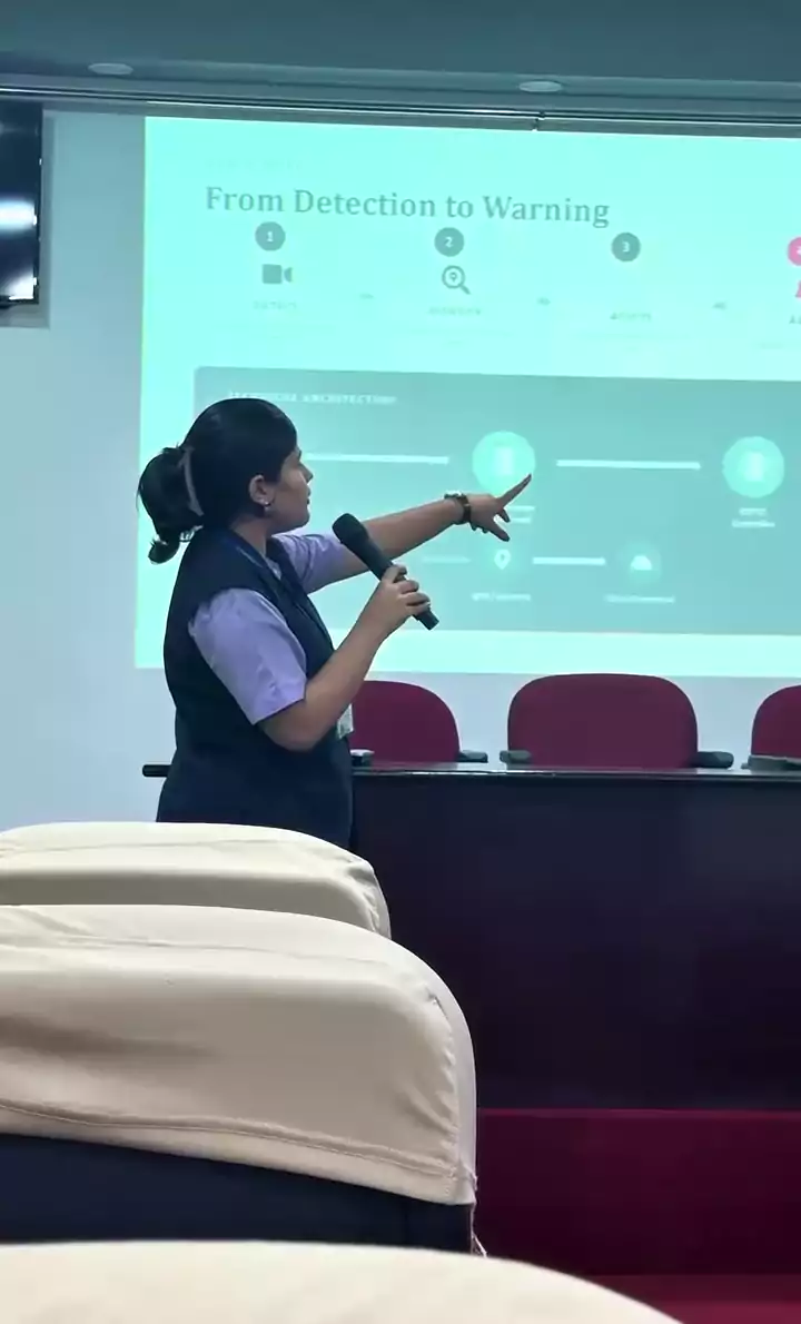 Student presenter pointing to a project slide